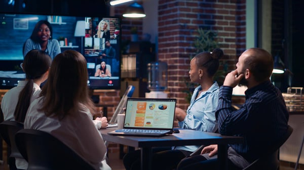 employees greeting remote team in video conference